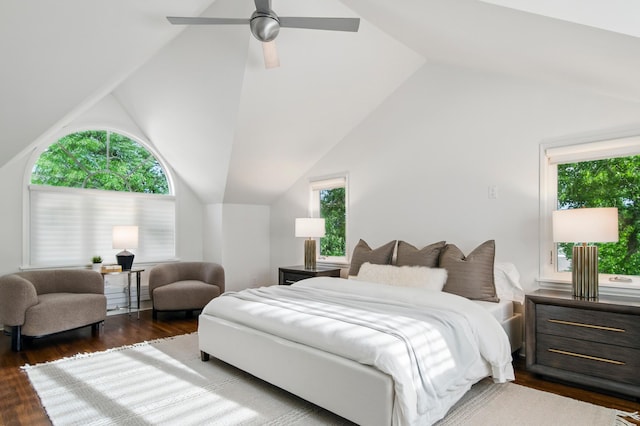 bedroom featuring dark wood finished floors, vaulted ceiling, and a ceiling fan
