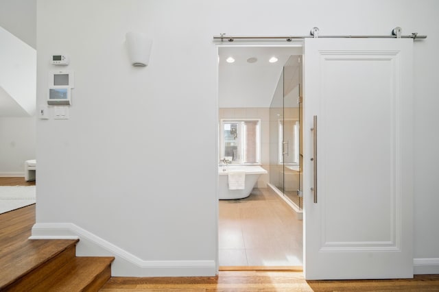 bathroom featuring a stall shower, a soaking tub, baseboards, and tile patterned floors
