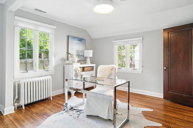 home office with radiator heating unit, wood finished floors, baseboards, lofted ceiling, and ornamental molding