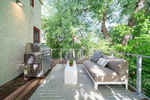 deck with an outdoor hangout area and area for grilling