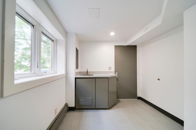 bar area with baseboards, a sink, light tile patterned floors, and recessed lighting