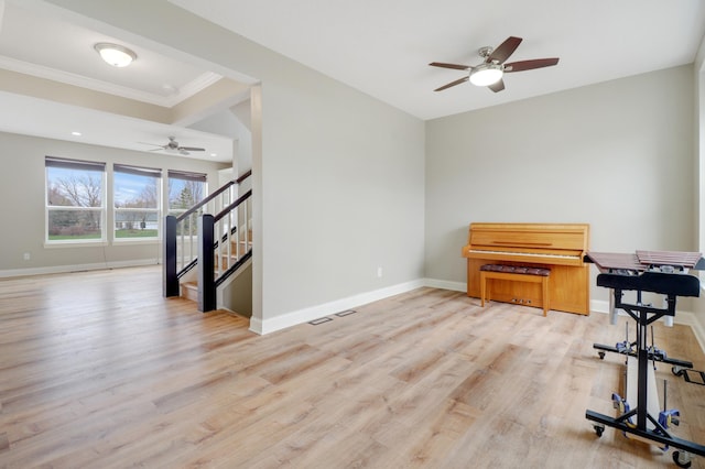 20024 Fern Glen Ln N, Forest Lake, MN 55025 - misc room featuring a ceiling fan, light wood-style flooring, baseboards, stairs, and crown molding