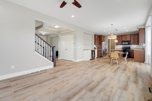 20024 Fern Glen Ln N, Forest Lake, MN 55025 - living area featuring wine cooler, ceiling fan, baseboards, stairway, and light wood finished floors