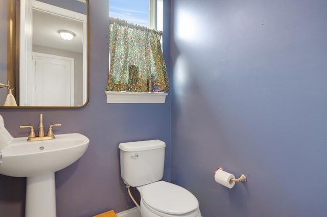 20024 Fern Glen Ln N, Forest Lake, MN 55025 - half bath featuring toilet, baseboards, and a sink