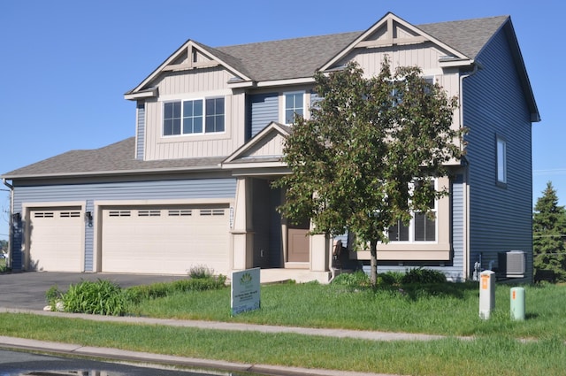 20024 Fern Glen Ln N, Forest Lake, MN 55025 - craftsman-style house featuring board and batten siding, central air condition unit, driveway, and roof with shingles