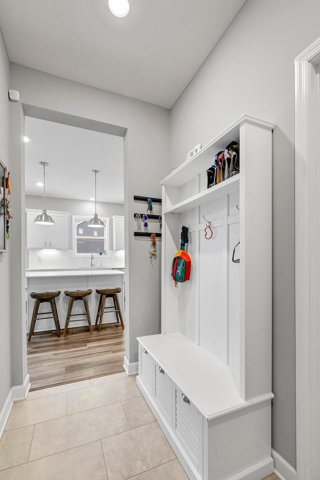mudroom featuring baseboards and light tile patterned floors