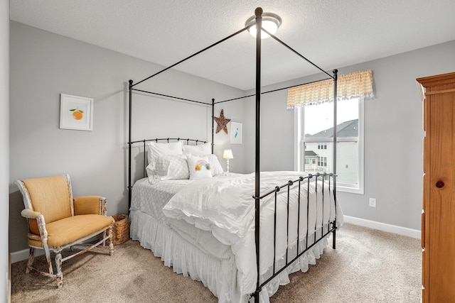 bedroom featuring a textured ceiling, baseboards, and light carpet