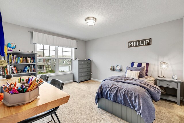 carpeted bedroom with baseboards and a textured ceiling