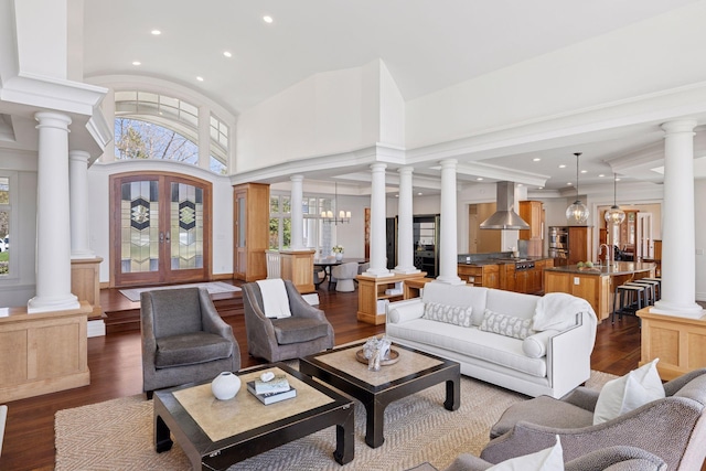 living room featuring recessed lighting, decorative columns, and dark wood-style floors