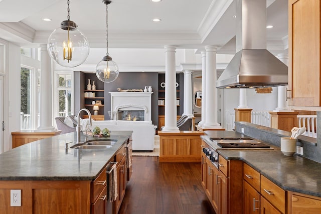 kitchen featuring dark wood-style flooring, island exhaust hood, a center island with sink, a sink, and open floor plan