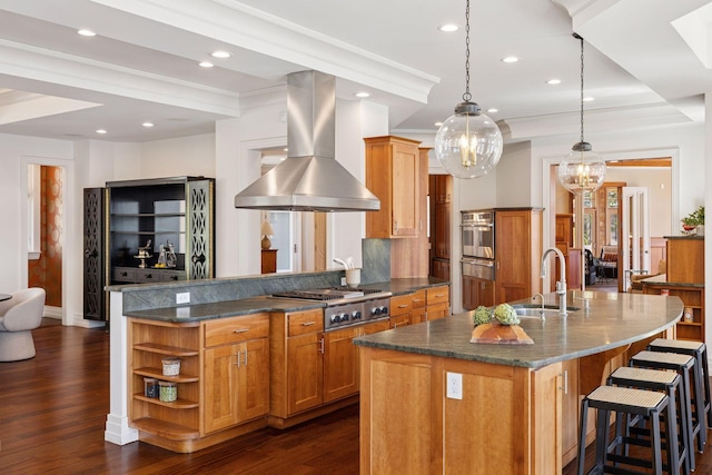 kitchen featuring brown cabinets, appliances with stainless steel finishes, a sink, island exhaust hood, and a warming drawer