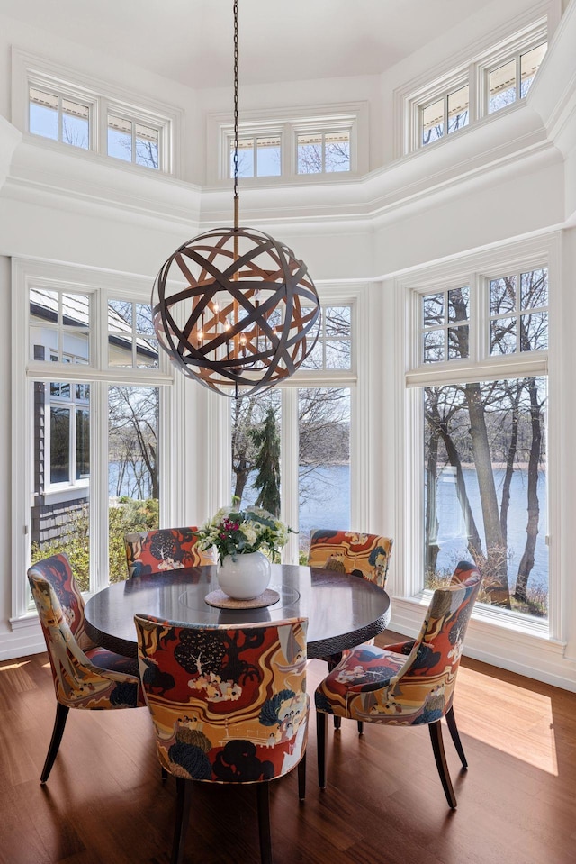 sunroom / solarium with a chandelier