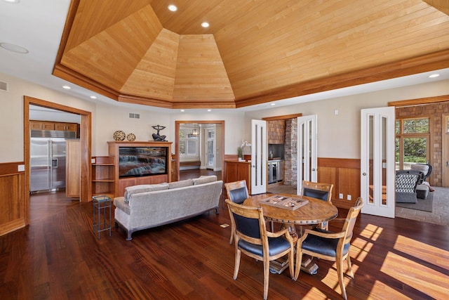 dining area featuring wood ceiling, a wainscoted wall, dark wood-style floors, and visible vents