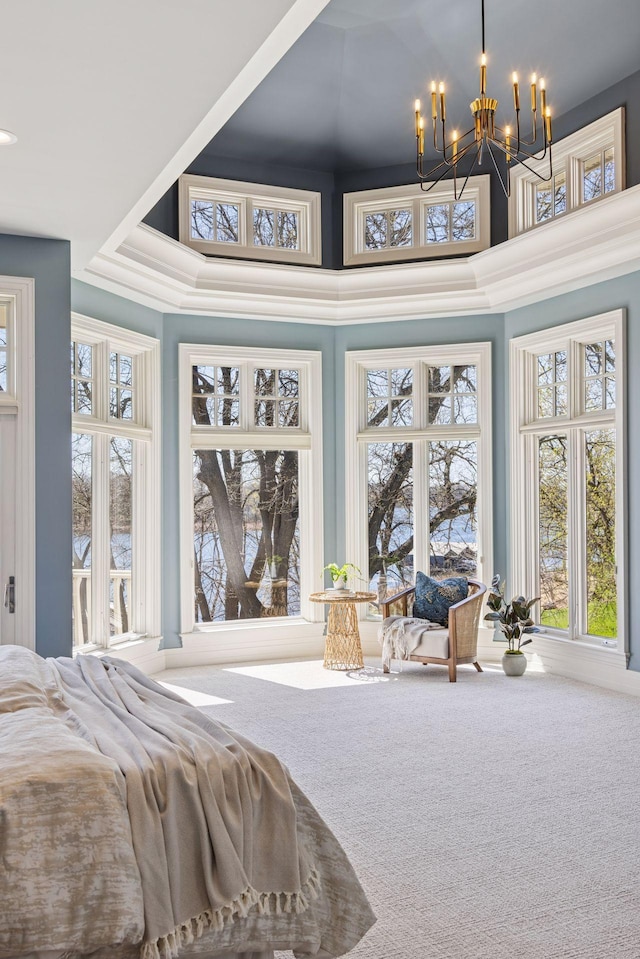 carpeted bedroom with a notable chandelier and multiple windows