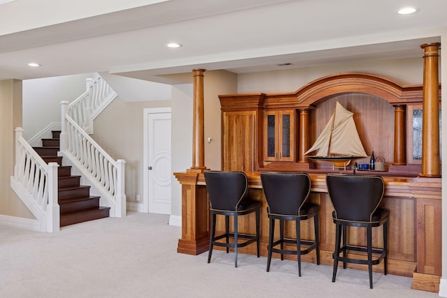 bar featuring stairway, recessed lighting, wet bar, and light colored carpet