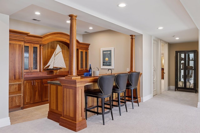 bar featuring light colored carpet, indoor wet bar, recessed lighting, decorative columns, and visible vents