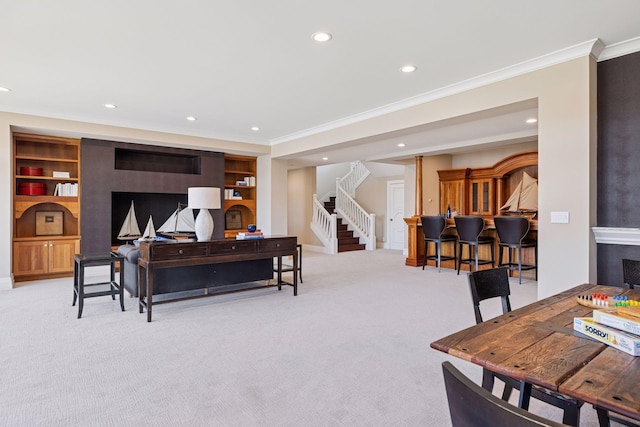 living room featuring recessed lighting, ornamental molding, light carpet, and stairs