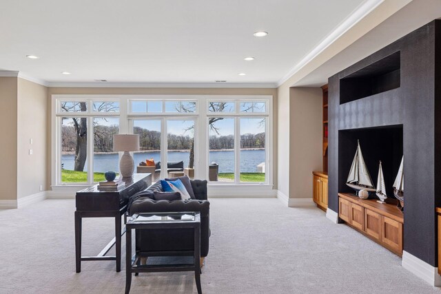 living room with baseboards, ornamental molding, and light carpet