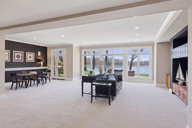 carpeted living room featuring crown molding, baseboards, and recessed lighting