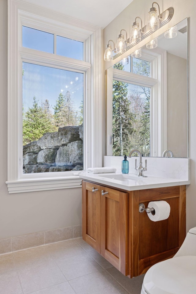 bathroom featuring vanity, toilet, and tile patterned floors