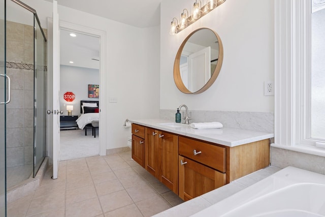 ensuite bathroom featuring a shower stall, vanity, tile patterned floors, ensuite bathroom, and recessed lighting