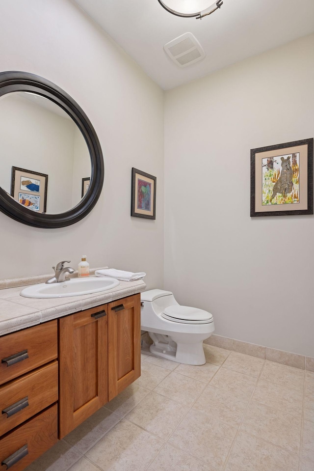 bathroom with vanity, tile patterned floors, visible vents, and toilet