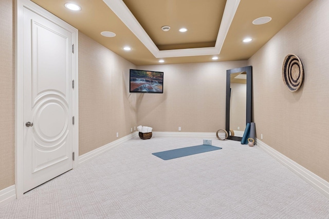 exercise area featuring a tray ceiling, baseboards, carpet flooring, and recessed lighting