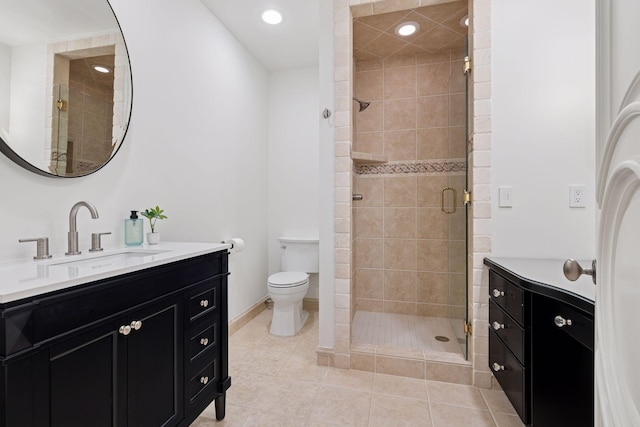 full bathroom with toilet, a shower stall, tile patterned flooring, and vanity