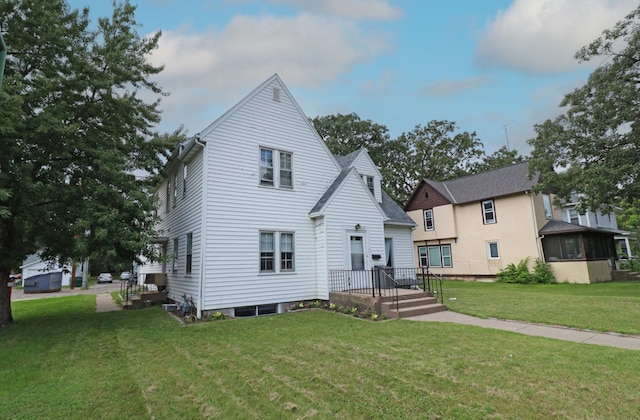 back of property featuring a lawn
