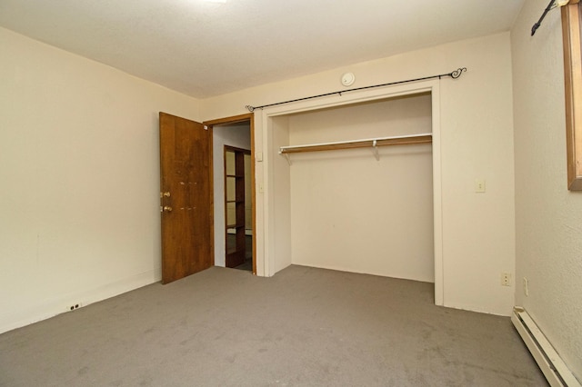 unfurnished bedroom featuring a baseboard radiator, a closet, and carpet