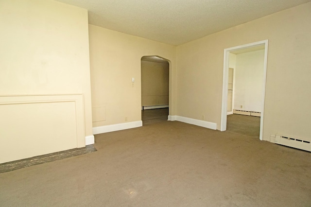 carpeted spare room featuring arched walkways, a baseboard heating unit, and a textured ceiling