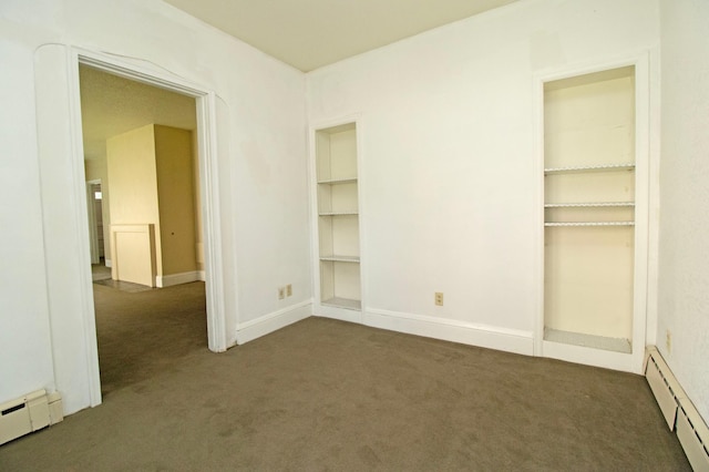 unfurnished bedroom with carpet flooring, a baseboard radiator, and baseboards