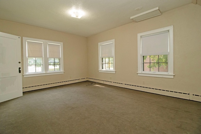 empty room with baseboard heating and carpet floors