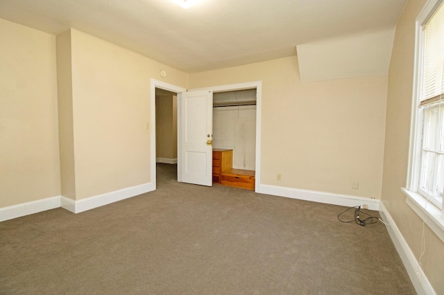 unfurnished bedroom with a closet, carpet, and baseboards