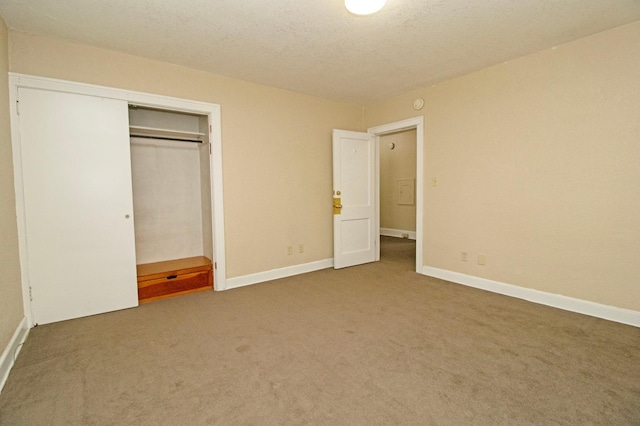 unfurnished bedroom with a closet, baseboards, and carpet floors