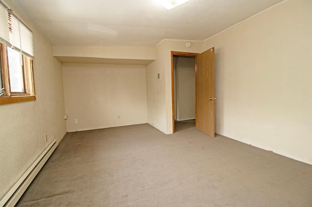 carpeted spare room with a baseboard radiator