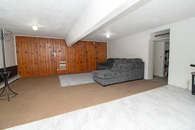 sitting room featuring wood walls, a textured ceiling, concrete block wall, and carpet floors