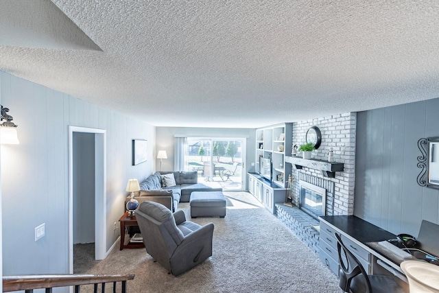 carpeted living room with a fireplace and a textured ceiling
