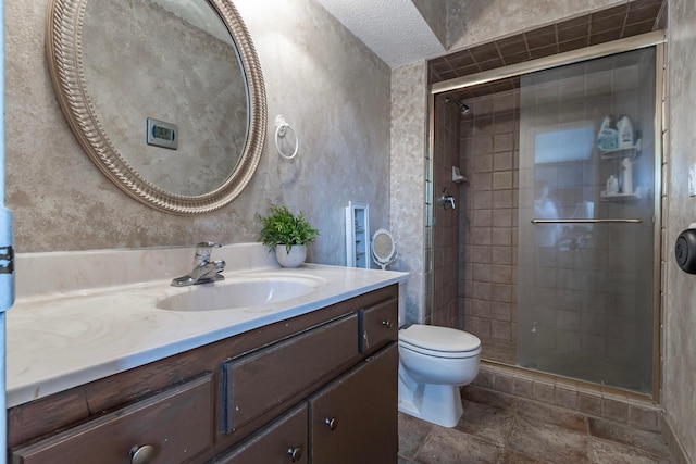 full bathroom with vanity, a textured ceiling, toilet, a shower stall, and stone finish flooring