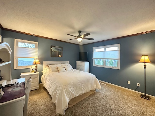 bedroom with baseboards, ornamental molding, a textured ceiling, carpet floors, and ceiling fan
