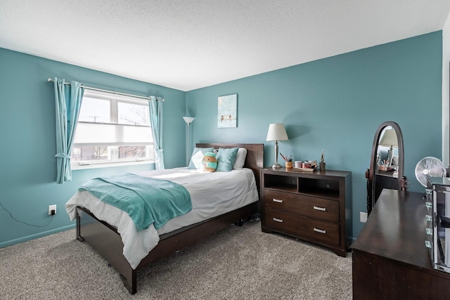 bedroom with baseboards, carpet, and a textured ceiling