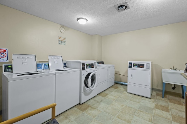 120 Demont Ave E Unit 103, Little Canada, MN 55117 - shared laundry room with washing machine and clothes dryer and a textured ceiling