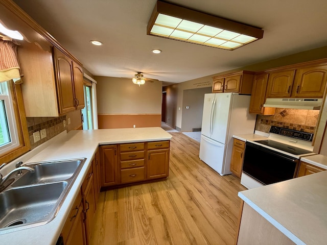 603 Maple Ave, Olivia, MN 56277 - kitchen featuring electric range, freestanding refrigerator, light wood-style floors, recessed lighting, and a peninsula