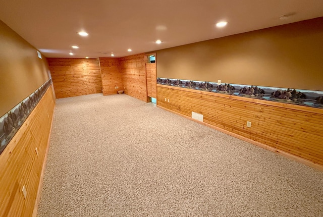 603 Maple Ave, Olivia, MN 56277 - empty room with wood walls, carpet flooring, and recessed lighting