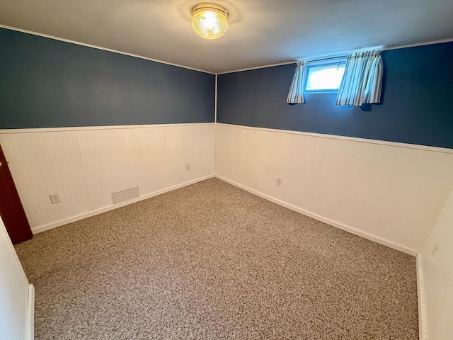 603 Maple Ave, Olivia, MN 56277 - carpeted spare room featuring wainscoting