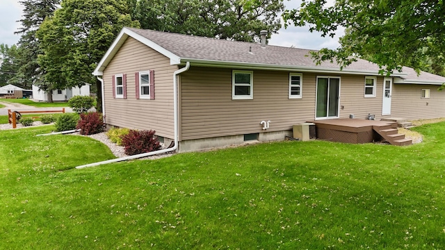 603 Maple Ave, Olivia, MN 56277 - back of house with a lawn, a deck, and roof with shingles