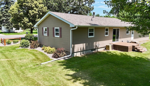 603 Maple Ave, Olivia, MN 56277 - back of house featuring roof with shingles, a yard, and a deck