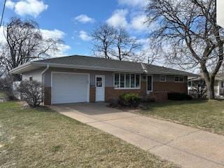 ranch-style house featuring driveway, an attached garage, and a front yard