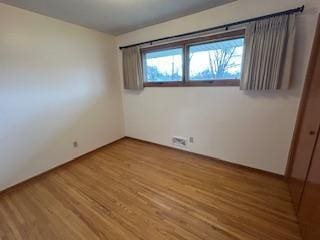 spare room featuring wood finished floors