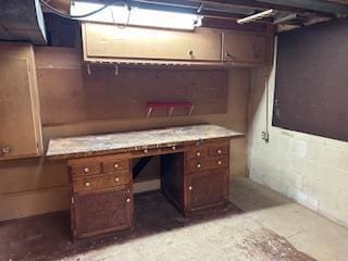 unfinished below grade area featuring concrete block wall